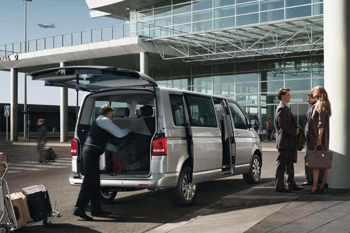 people with shuttle standing at airport